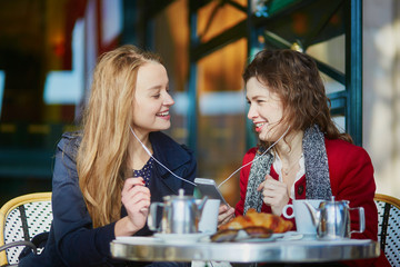 Two young girls in Parisian outdoor cafe
