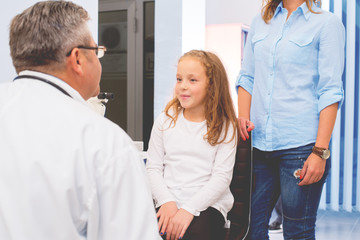 Doctor examining a child patient.Colored photo