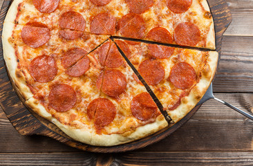 Pepperoni pizza on a board