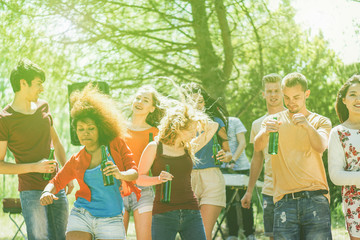 Multiracial young people dancing in forest party in summer time