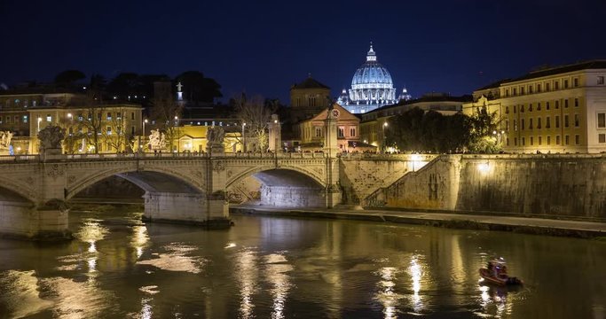 Rome, Italy - illuminated san angelo bridge with Tiber river at night with view of St Peters Basilica - Timelapse with motion - New Years Eve