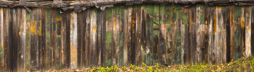 Texture wooden fence with horizontal yellow boards and faded pai