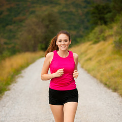 runner - woman runns  on a forest road - outdoor  workout