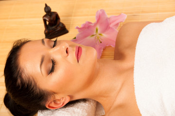 Obraz na płótnie Canvas Beautiful young woman having a face massage in wellness studio -