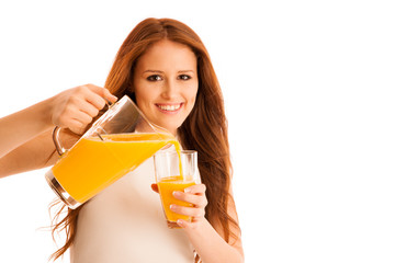 Woman drinking orange juice smiling showing oranges. Young beaut