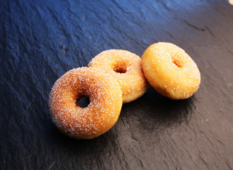 Colorful donuts on stone table