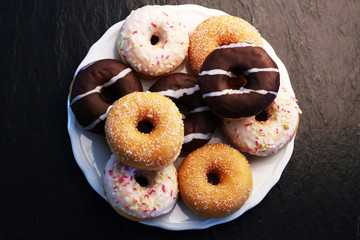 Colorful donuts on stone table