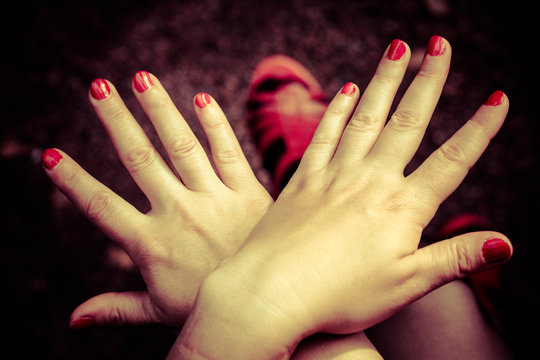 Women's hands. Fingers spread apart. On the red nail polish.