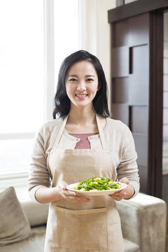 Happy Young Woman Serving Food