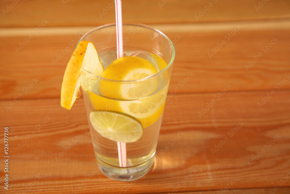 Wall mural lemonade in a glass on wooden table