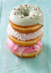 colorful doughnuts on turquoise wooden surface