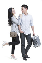 Obraz premium Happy young couple traveling with luggage