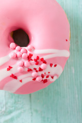 pink doughnut on turquoise wooden background