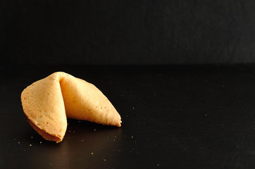 A fortune cookie isolated on a black background