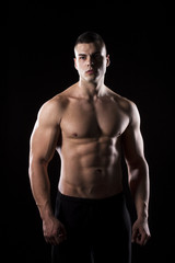 Fototapeta premium Strong young man showing his muscles 