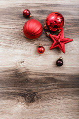 Red Christmas ornaments on a rustic wooden background. Xmas card. Happy New Year. Top view with copy space