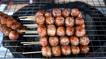 Sausage skewers on the grill grate steel.