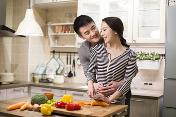 Young couple cooking in kitchen