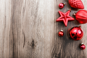 Red Christmas ornaments on a rustic wooden background. Xmas card. Happy New Year. Top view with copy space