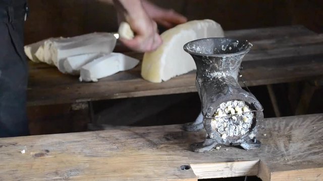 bryndza feta cheese creation in the Carpathian Mountains, Ukraine, twisted in a meat grinder close-up. National way to create cheese bryndza from cow's milk or sheep on the Carpathian Poloniny