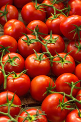 Fresh ripe red tomatoes in wooden box in the market for sale 