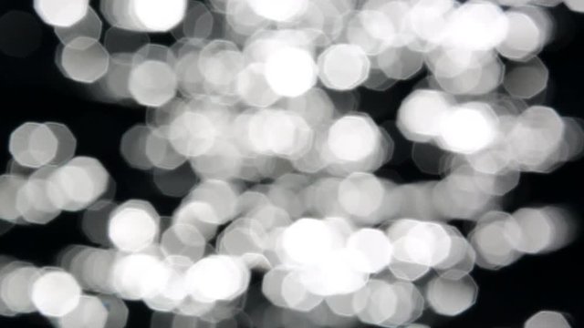 Big and Dark Bokeh of the Sun Glares Reflected From Water