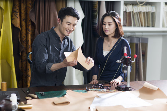 Craftsman and customer talking in studio