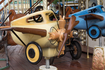 Retro plane on the carousel street. Carnival