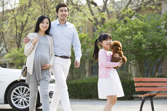Happy young family with their pet dog