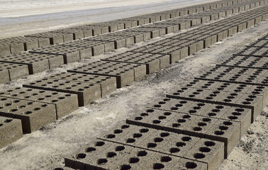 Cinder blocks lie on the ground and dried. on cinder block production plant.