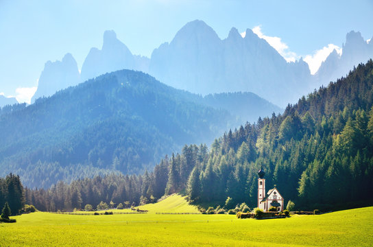 Funes Valley, Dolomites, Italy. St John church under autumn sun, in front of the Odle mountain.St maddalena Europe Original turistic wallpaper,