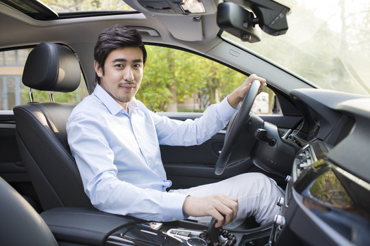 Young man driving car