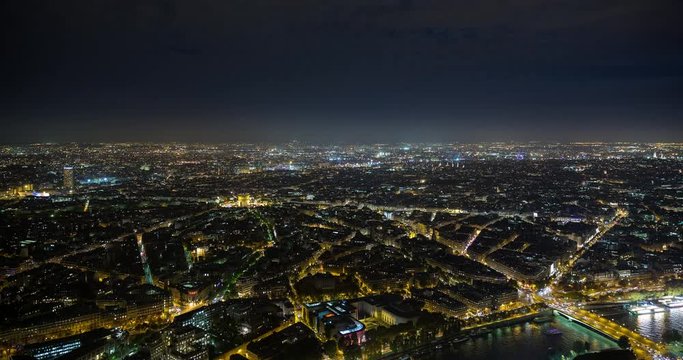 Paris, France - view over illuminated Paris by night with moonlight and clouds - Timelapse