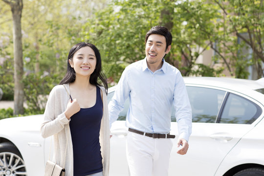 Happy Young Couple And Car