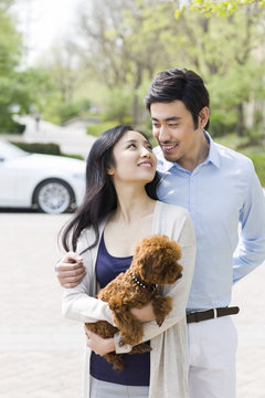Happy young couple with their pet dog