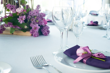 Festive table setting in the restaurant with flowers. Wedding decor.