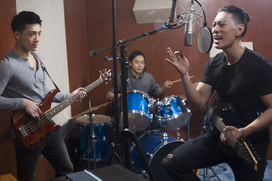 Musical band in recording studio