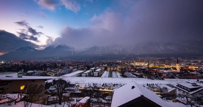Innsbruck, Austria - view from Bichlweg / Ambraser Castle-Park via Innsbruck on snowy Alps at sunset - Timelapse with pan left to right