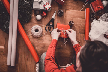 Woman Wrapping Christmas Gifts At Home