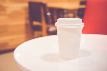 Close up white coffee cup on table at cafe,Vintage filter