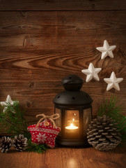 candle lantern spruce twigs cones knitted heart on wooden background