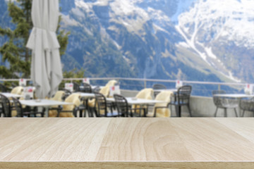 Wood table top and blurred restaurant exterior background - can used for display or montage your products.