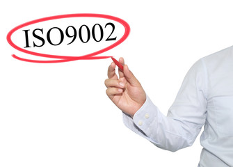 Hand of man write text ISO 9002 with black color isolated on whi