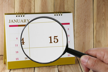 Magnifying glass in hand on calendar you can look Fifteenth day
