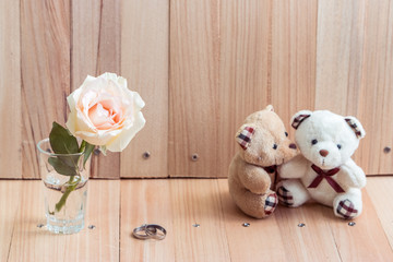 Embrace Bears in love sit near bouquet rose. Love is in the air., set for celebrating in engagement party, Valentine concept