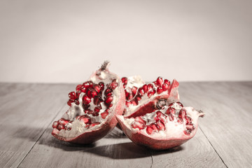pomegranates on a white wooden background 2