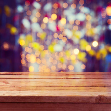 Christmas holiday background with empty wooden deck table over beautiful bokeh. Ready for product montage