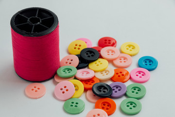 Spool of thread and buttons, sew instrument isolated on white ba