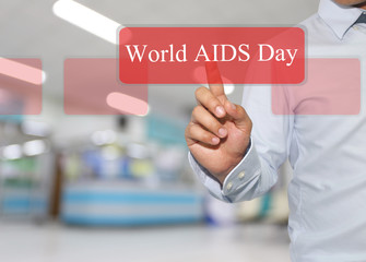 Hand of businessman touch text in STOP AIDS on Hospital blurred