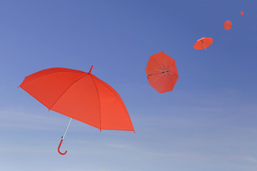 Red umbrella blown by the wind.